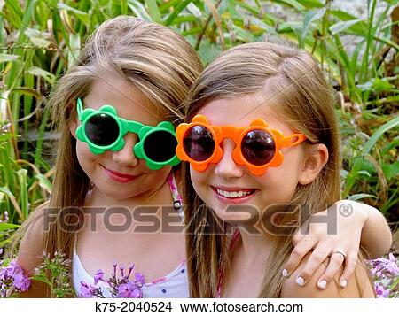 Fraternal twins wearing sunglasses View Large Photo Image Picture - Fraternal twins wearing sunglasses. Fotosearch