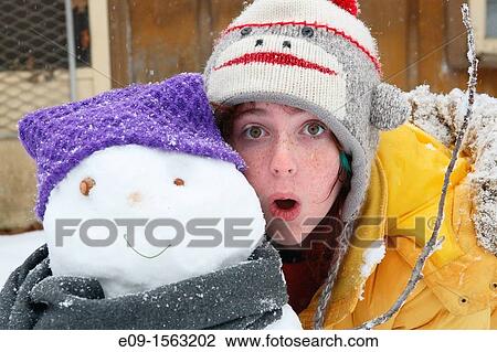 freckled girl in sock-monkey hat and yellow parka, standing with mouth open beside the snowman she built - snowman has purple hat, grey scarf View Large Photo Image Stock Image - freckled girl in sock-monkey hat and yellow parka, standing with mouth open beside the snowman she built - snowman has purple hat, grey scarf. Fotosearch