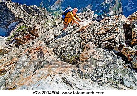 Picture - free solo rock climbing The Direct South Ridge route which is rated grade 3 at 5, 7 on Nez Perce Peak in Grand Teton National Park in northern Wyoming.. Fotosearch