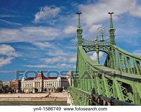 Freedom bridge across the Danube River at Budapest, Hungary The landmark Gellert Hotel is on the shore of the Danube on the Buda side of the River View Large Photo Image Stock Photo - Freedom bridge across the Danube River at Budapest, Hungary The landmark Gellert Hotel is on the shore of the Danube on the Buda side of the River. Fotosearch