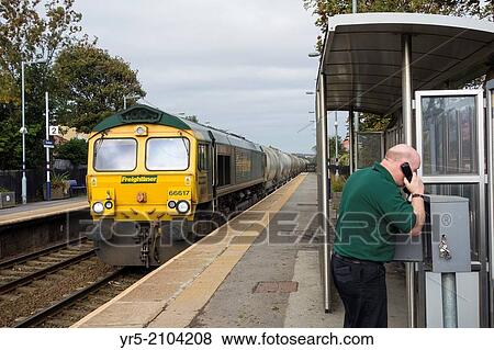 Stock Photo - Freightliner train driver calling signal box from Seaham station on the East Coast line in north east England, United Kingdom.. Fotosearch