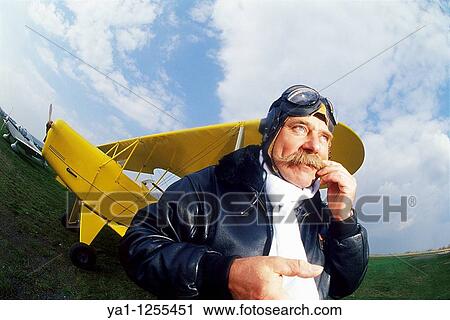 French pilot scratching his mustaches front of his biplane View Large Photo Image Stock Image - French pilot scratching his mustaches front of his biplane. Fotosearch
