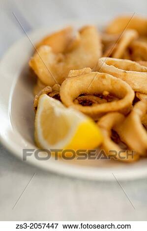 Fried Calamaries on plate served with lemon, Koufonissi, Cyclades Islands, Greek Islands, Greece, Europe. View Large Photo Image Stock Photo - Fried Calamaries on plate served with lemon, Koufonissi, Cyclades Islands, Greek Islands, Greece, Europe.. Fotosearch