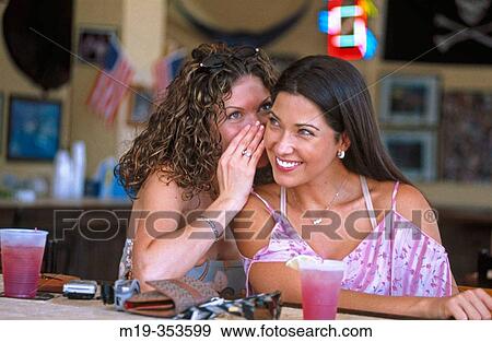 Friend telling a secret View Large Photo Image Stock Photo - Friend telling a secret. Fotosearch