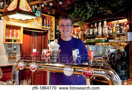 Friendly bartender behind bar serving drinks in quiet small town of Edam Holland outside of Amsterdam with great small peaceful feel at de Prinsen Bar View Large Photo Image Stock Image - Friendly bartender behind bar serving drinks in quiet small town of Edam Holland outside of Amsterdam with great small peaceful feel at de Prinsen Bar. Fotosearch