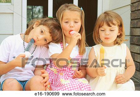 Friends eating popsicle View Large Photo Image Stock Photo - Friends eating popsicle. Fotosearch