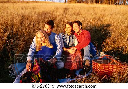 Friends enjoying the setting sun View Large Photo Image Stock Photography - Friends enjoying the setting sun. Fotosearch
