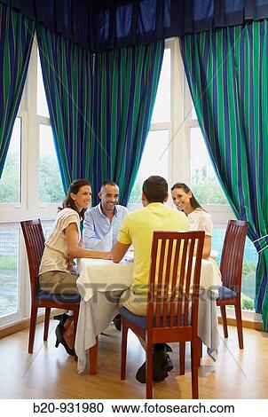 Friends in a restaurant View Large Photo Image Stock Image - Friends in a restaurant. Fotosearch