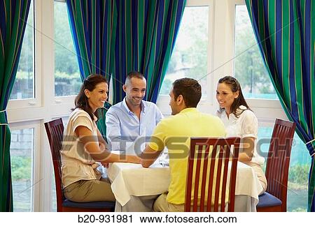 Friends in a restaurant View Large Photo Image Stock Image - Friends in a restaurant. Fotosearch