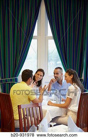 Friends in a restaurant View Large Photo Image Stock Photo - Friends in a restaurant. Fotosearch