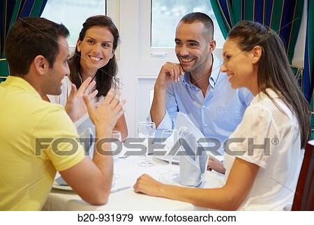 Stock Photo - Friends in a restaurant. Fotosearch