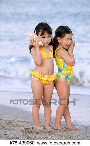 friends listening to seashells View Large Photo Image Stock Image - friends listening to seashells. Fotosearch