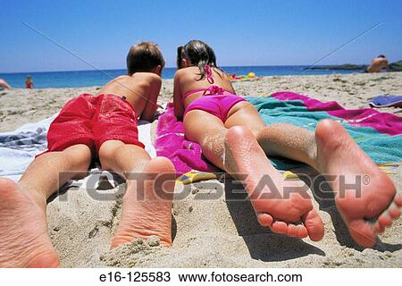 Friends lying together at the beach View Large Photo Image Stock Image - Friends lying together at the beach. Fotosearch