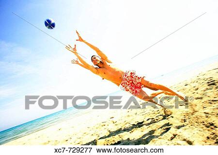 Friends playing on beach View Large Photo Image Stock Photo - Friends playing on beach. Fotosearch
