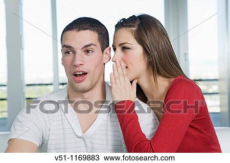Stock Image - Friends sharing a secret. Fotosearch