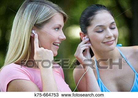 Friends sharing an mp 3 player View Large Photo Image Stock Image - Friends sharing an mp 3 player. Fotosearch