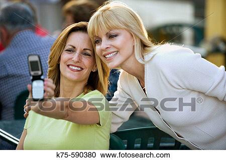 Friends taking photo with cell phone camera View Large Photo Image Stock Image - Friends taking photo with cell phone camera. Fotosearch