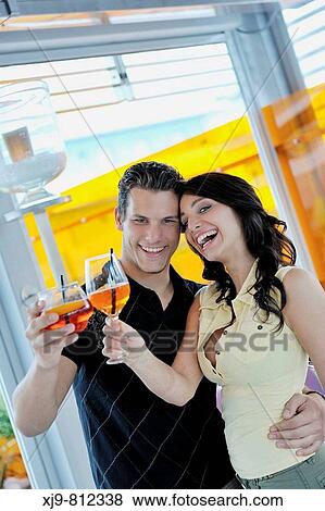 Stock Photo - Friends toasting at bar.. Fotosearch