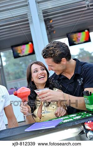 Stock Photo - Friends toasting at bar.. Fotosearch