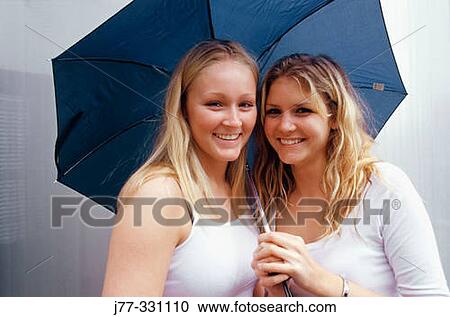 Friends under an umbrella View Large Photo Image Stock Image - Friends under an umbrella. Fotosearch