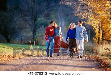 Friends walking to a picnic View Large Photo Image Stock Image - Friends walking to a picnic. Fotosearch