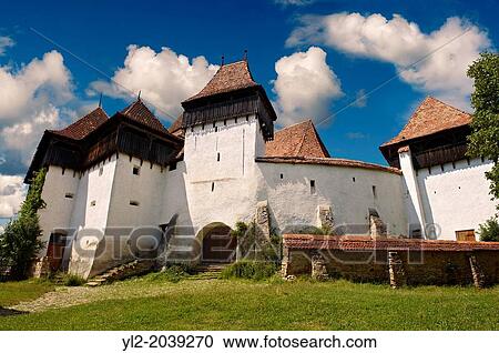 Stock Image - Front view of the Szekly medieval fortified church of Viscri, Bunesti, Brasov, Transylvania. Started in the 1100? s. UNESCO World Heritage Site.. Fotosearch