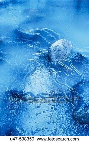 Stock Photo - Frozen creek in winter. Evening light. Western Montana. USA. Fotosearch