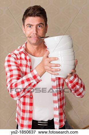 Frustrated adult male preparing meal in a hurry View Large Photo Image Stock Photo - Frustrated adult male preparing meal in a hurry. Fotosearch