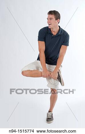 Full-body photograph of a teenage boy standing with a jump or making a pirouette. View Large Photo Image Picture - Full-body photograph of a teenage boy standing with a jump or making a pirouette.. Fotosearch