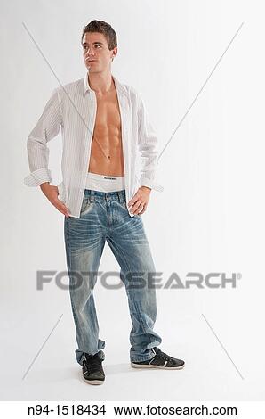 Full-body photograph of a teenage boy in jeans and white shirt open. View Large Photo Image Picture - Full-body photograph of a teenage boy in jeans and white shirt open.. Fotosearch