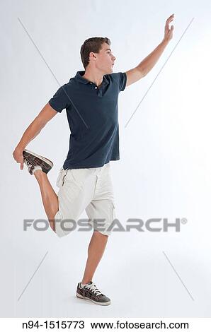 Full-body photograph of a teenage boy standing with a jump or making a pirouette. View Large Photo Image Stock Image - Full-body photograph of a teenage boy standing with a jump or making a pirouette.. Fotosearch