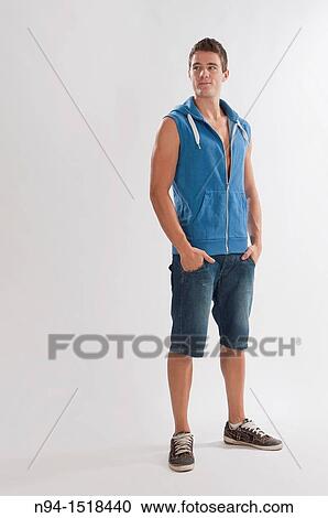 Full-body photograph of a teenage boy, with jeans and short blue sleeveless vest. View Large Photo Image Stock Image - Full-body photograph of a teenage boy, with jeans and short blue sleeveless vest.. Fotosearch