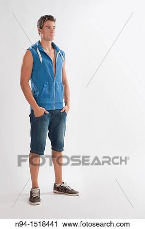 Full-body photograph of a teenage boy, with jeans and short blue sleeveless vest. View Large Photo Image Stock Image - Full-body photograph of a teenage boy, with jeans and short blue sleeveless vest.. Fotosearch