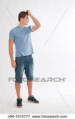 Full-body photograph of a teenage boy standing with hands in hair. View Large Photo Image Stock Photo - Full-body photograph of a teenage boy standing with hands in hair.. Fotosearch