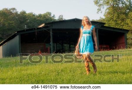Full length portrait of a 35 year old blond woman in casual blue dress and brown boots outdoors in a country setting. View Large Photo Image Stock Photography - Full length portrait of a 35 year old blond woman in casual blue dress and brown boots outdoors in a country setting.. Fotosearch