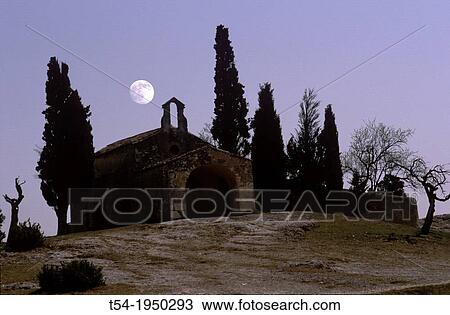Stock Image - Full moon over a small chapel in southern France. Fotosearch