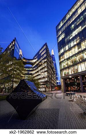 Stock Image - Full stop klang sculpture and 7 More London, near city hall, UK. Fotosearch