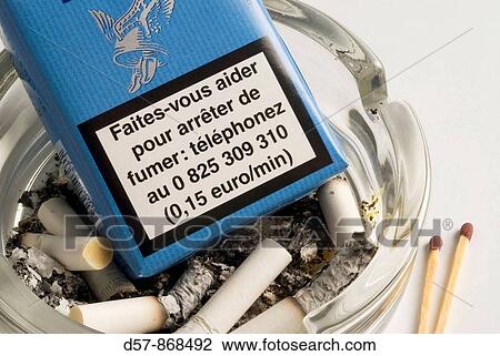 Stock Image - Fumer tue. French cigarette pack. Smoking kills. Ashtray. Matches.. Fotosearch