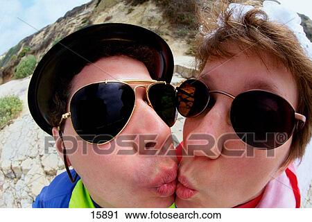 Funny portrait of couple kissing View Large Photo Image Stock Image - Funny portrait of couple kissing. Fotosearch