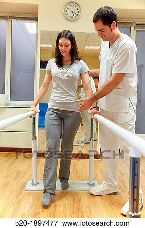 Stock Photo - Gait training in parallel Gym Physiotherapy medical center, Donostia, San Sebastian, Gipuzkoa, Basque Country, Spain. Fotosearch
