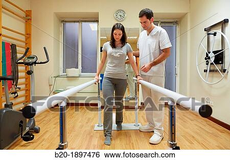 Stock Photograph - Gait training in parallel Gym Physiotherapy medical center, Donostia, San Sebastian, Gipuzkoa, Basque Country, Spain. Fotosearch