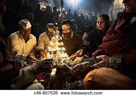 Ganga Arti ceremony to express respect for Mother Ganges as well as goddess Shiva and purify the air pollution. Involves burning incense, chanting & ringing of bells. The ceremony is performed every evening at sunset. Varanasi, River Ganges, India View Large Photo Image Stock Photo - Ganga Arti ceremony to express respect for Mother Ganges as well as goddess Shiva and purify the air pollution. Involves burning incense, chanting & ringing of bells. The ceremony is performed every evening at sunset. Varanasi, River Ganges, India. Fotosearch