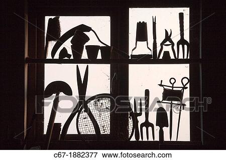 Stock Photo - Garden tools in potting shed window. Fotosearch