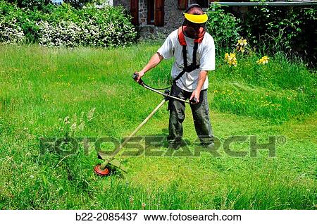Stock Photo - Gardener cutting of the grass, La Bessi? re, Campuac, Aveyron, Midi-Pyr? n? es, France.. Fotosearch