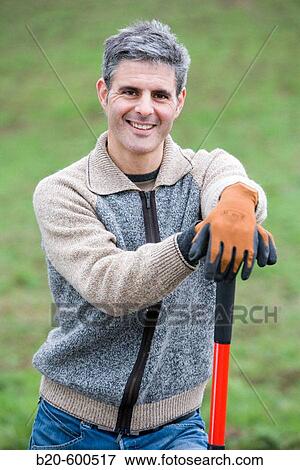 Stock Photo - Gardener with shovel. Agricultural works. Gipuzkoa, Euskadi. Spain.. Fotosearch