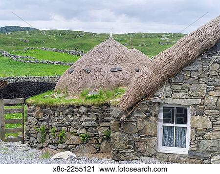 Garenin Blackhouse Village (Gearrannan Baile-Tughaidh on the Isle of Lewis in the Outer Hebrides. Das Blackhouse Village is part museum part holliday accomodation. Europe, Scotland, June. View Large Photo Image Stock Image - Garenin Blackhouse Village (Gearrannan Baile-Tughaidh on the Isle of Lewis in the Outer Hebrides. Das Blackhouse Village is part museum part holliday accomodation. Europe, Scotland, June.. Fotosearch