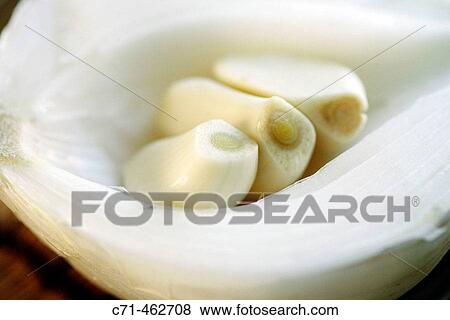 Garlic inside of a onion View Large Photo Image Stock Photo - Garlic inside of a onion. Fotosearch