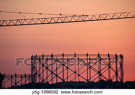 gas tower and crane at sunset in rome italy. View Large Photo Image Stock Image - gas tower and crane at sunset in rome italy.. Fotosearch