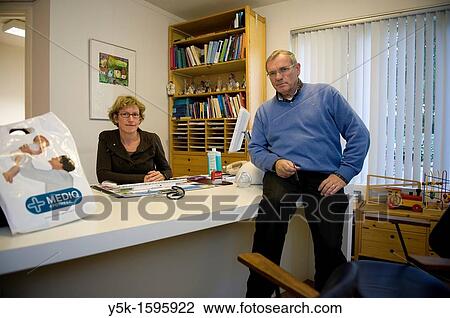 General practitioner male and his assistant female in chambers, where they receive patients. View Large Photo Image Stock Image - General practitioner male and his assistant female in chambers, where they receive patients.. Fotosearch