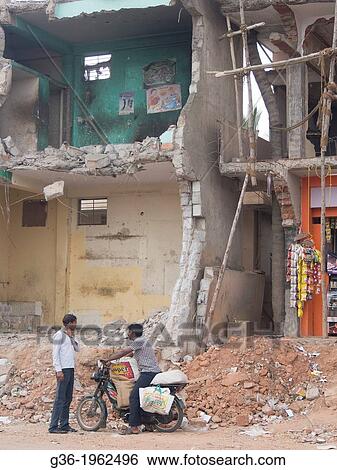 General store and motorbike, a building that was partly removed to make way for upcoming highway in Yelahanka, Karnataka, India. View Large Photo Image Stock Photograph - General store and motorbike, a building that was partly removed to make way for upcoming highway in Yelahanka, Karnataka, India.. Fotosearch